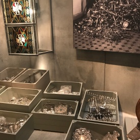 Display of valuables stolen from Jewish homes and synagogues Silverware but also stain glass windows were stolen. This display of them sorted in boxes but jumbled together was very striking and really hit home what had been lost in both spiritual and financial terms.